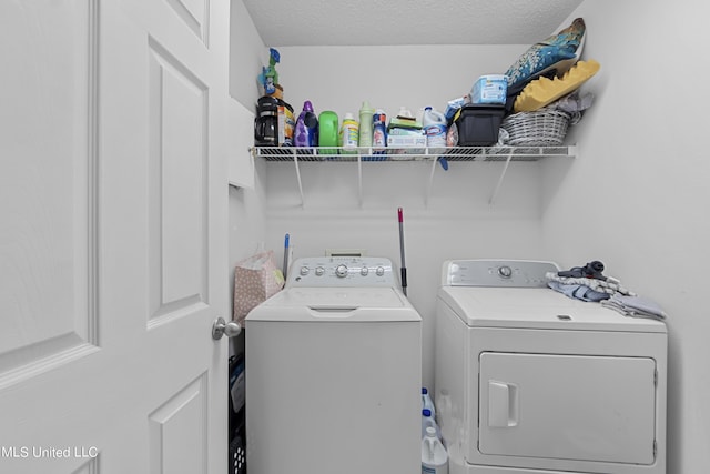clothes washing area featuring washer and dryer and laundry area