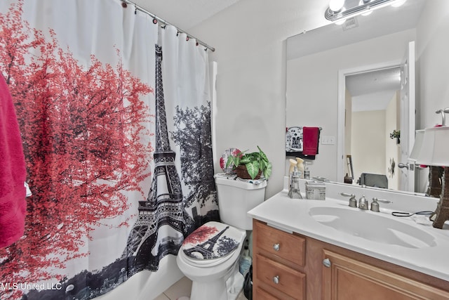 full bath with toilet, vanity, and shower / bath combo with shower curtain