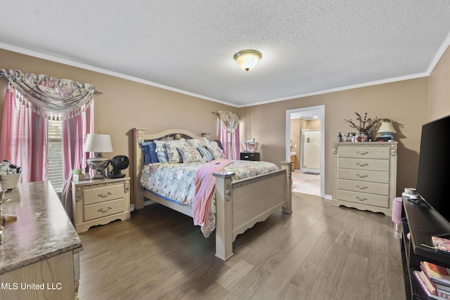 bedroom featuring ensuite bath, wood finished floors, a textured ceiling, and ornamental molding