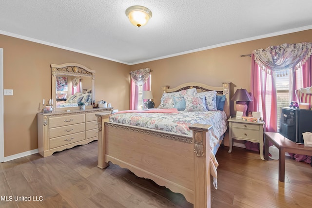 bedroom featuring ornamental molding, hardwood / wood-style floors, and a textured ceiling