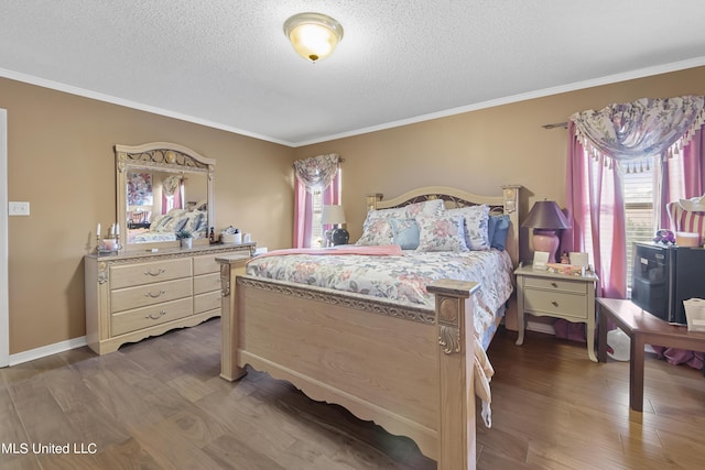 bedroom featuring crown molding, wood finished floors, and a textured ceiling