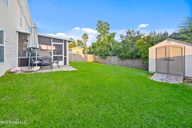 view of yard featuring a shed and a patio