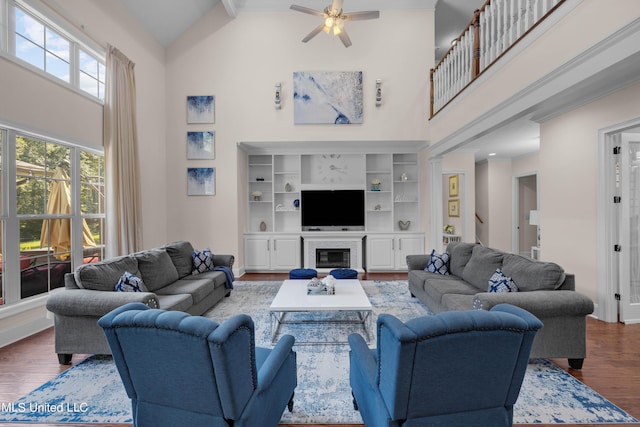 living room with hardwood / wood-style flooring, high vaulted ceiling, beamed ceiling, and ceiling fan