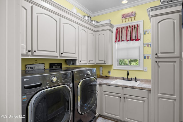 washroom featuring sink, independent washer and dryer, crown molding, and cabinets