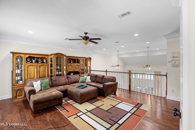 living room with hardwood / wood-style floors, crown molding, and ceiling fan