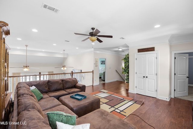 living room featuring crown molding, dark hardwood / wood-style floors, and ceiling fan