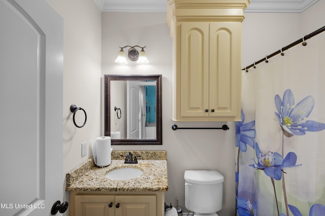 bathroom with vanity, toilet, and crown molding