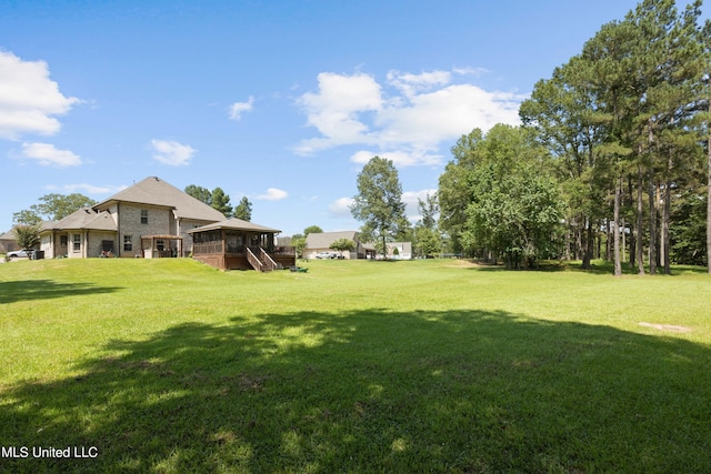 view of yard featuring a wooden deck