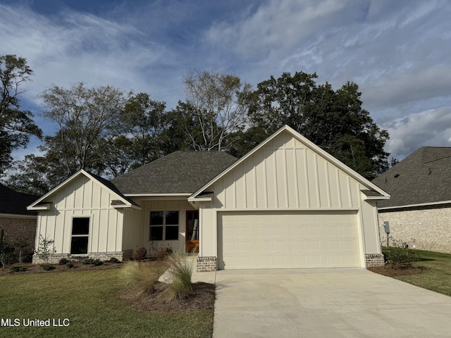 412 Butternut Dr Unit 184, Canton, MS 39046 - view of front facade featuring board and batten siding, an attached garage, driveway, a shingled roof, and brick siding