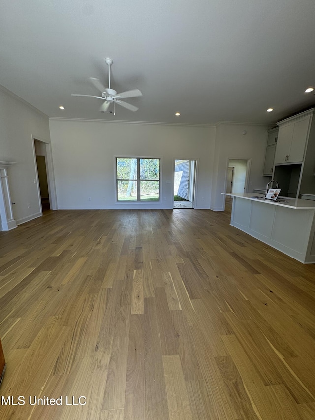 412 Butternut Dr Unit 184, Canton, MS 39046 - unfurnished living room with ornamental molding, a ceiling fan, light wood-style flooring, baseboards, and recessed lighting