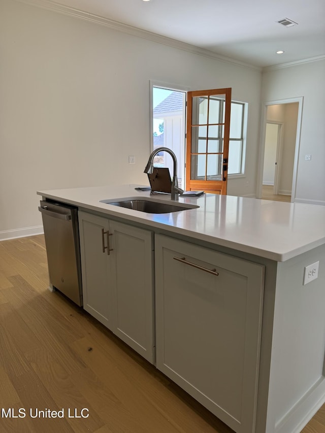 412 Butternut Dr Unit 184, Canton, MS 39046 - kitchen featuring a sink, stainless steel dishwasher, light wood-style flooring, an island with sink, and light countertops