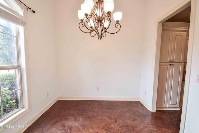 spare room with a chandelier