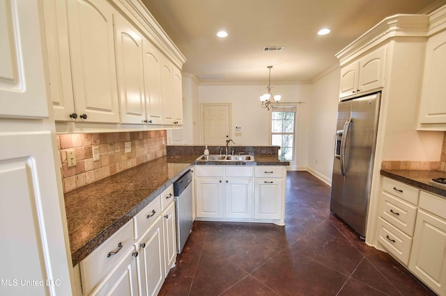 kitchen featuring kitchen peninsula, stainless steel appliances, ornamental molding, sink, and pendant lighting