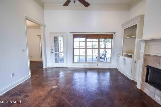 unfurnished living room with ornamental molding, a tile fireplace, built in features, and ceiling fan