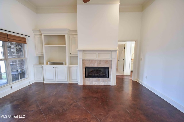 unfurnished living room with ornamental molding and a tile fireplace