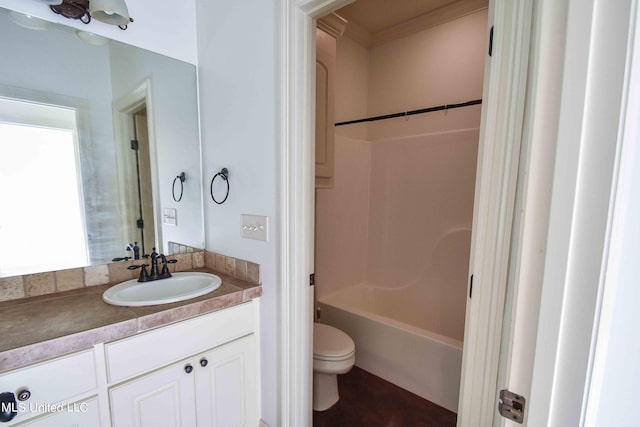 full bathroom featuring vanity, crown molding, bathing tub / shower combination, and toilet