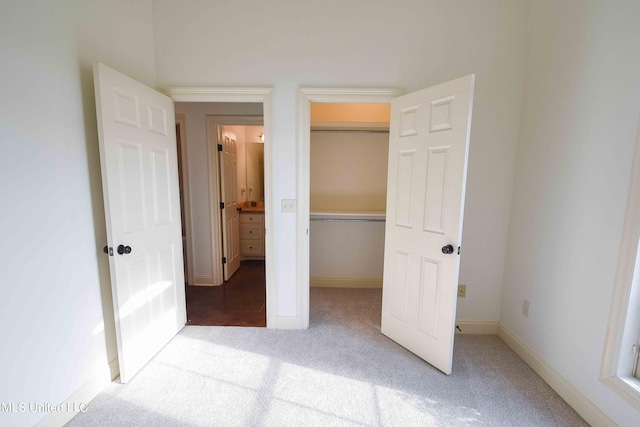 unfurnished bedroom with a closet and carpet floors