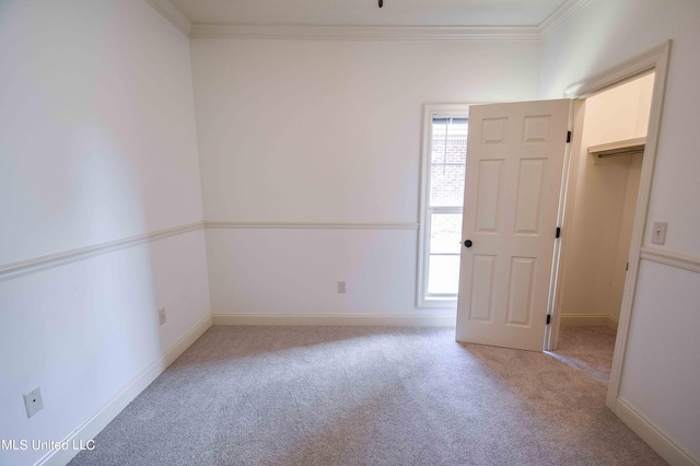 unfurnished room featuring ornamental molding and light colored carpet