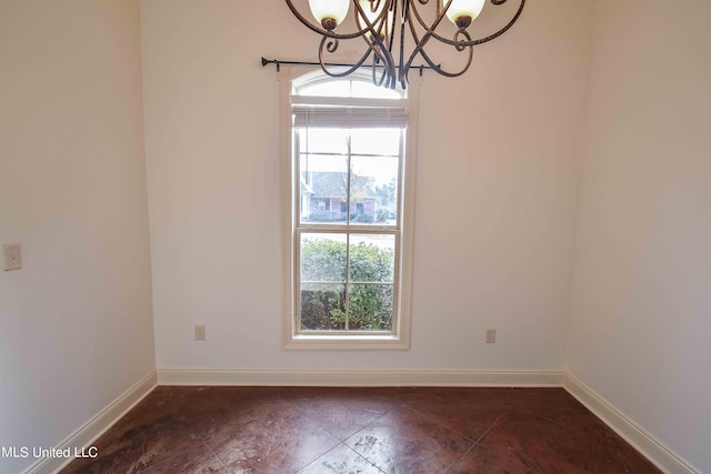 unfurnished room featuring a notable chandelier and plenty of natural light