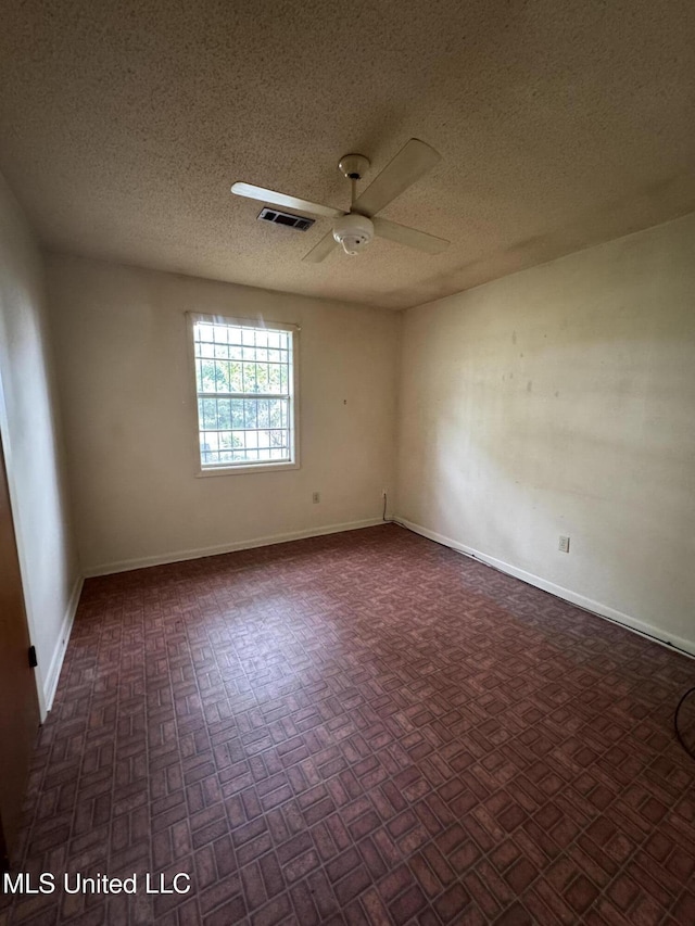 704 Oak Ave, Ruleville, MS 38771 - empty room with a textured ceiling, a ceiling fan, and baseboards