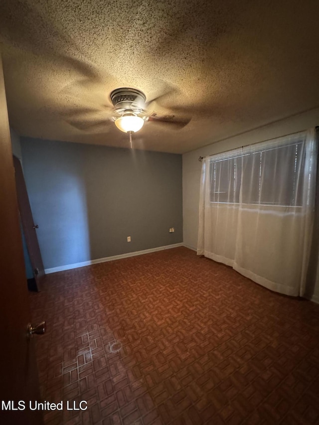 704 Oak Ave, Ruleville, MS 38771 - spare room featuring ceiling fan, a textured ceiling, and baseboards