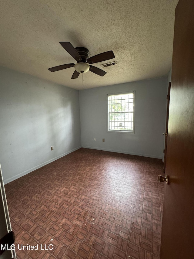 704 Oak Ave, Ruleville, MS 38771 - empty room featuring a ceiling fan, a textured ceiling, and baseboards