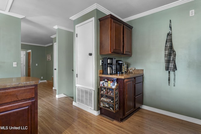 4620 Holly Heath Dr, Gautier, MS 39553 - bar featuring wood finished floors, baseboards, and ornamental molding