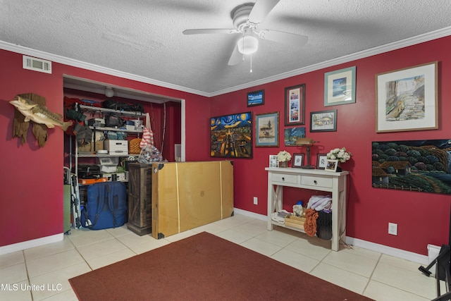 4620 Holly Heath Dr, Gautier, MS 39553 - interior space featuring a ceiling fan, tile patterned floors, a textured ceiling, ornamental molding, and baseboards