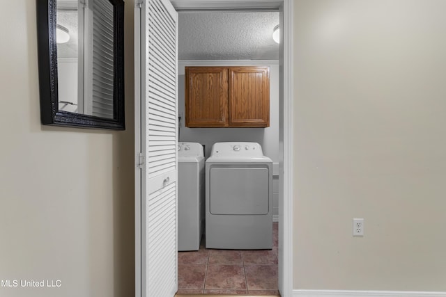 4620 Holly Heath Dr, Gautier, MS 39553 - laundry room featuring cabinet space, tile patterned floors, independent washer and dryer, baseboards, and a textured ceiling