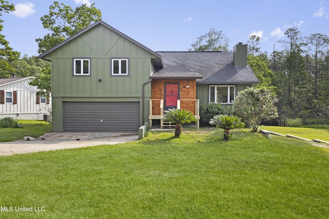 4620 Holly Heath Dr, Gautier, MS 39553 - split level home featuring a garage, a chimney, board and batten siding, concrete driveway, and a front lawn
