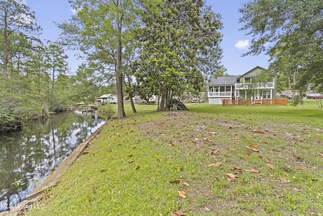 4620 Holly Heath Dr, Gautier, MS 39553 - view of grassy yard featuring a deck with water view