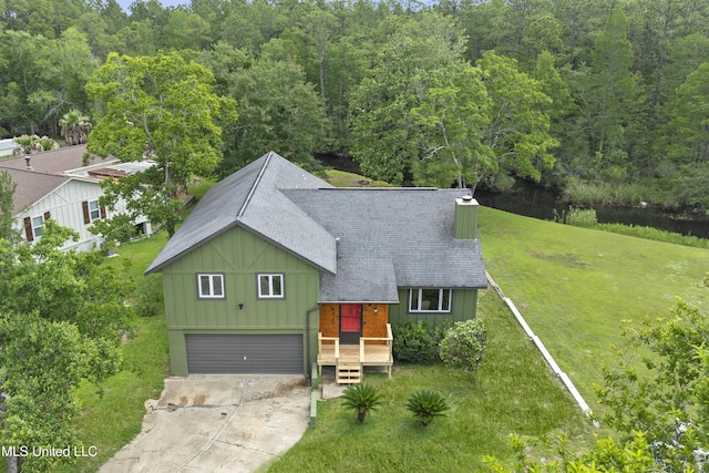 4620 Holly Heath Dr, Gautier, MS 39553 - view of front of home featuring board and batten siding, concrete driveway, a shingled roof, a front yard, and an attached garage