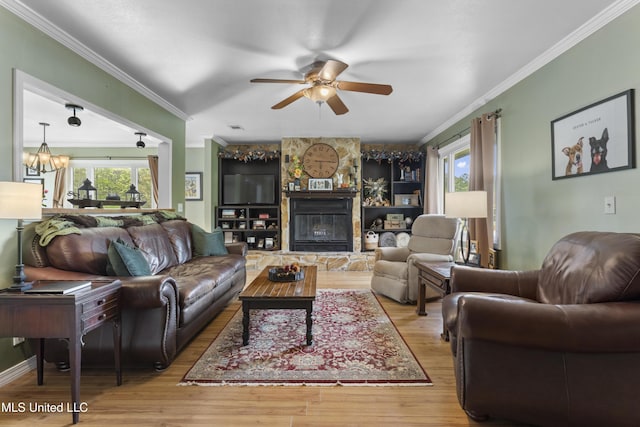 4620 Holly Heath Dr, Gautier, MS 39553 - living room featuring healthy amount of natural light, ceiling fan, wood finished floors, crown molding, and a fireplace