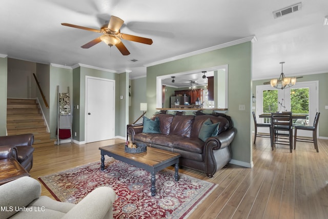 4620 Holly Heath Dr, Gautier, MS 39553 - living area with ceiling fan, stairway, a chandelier, crown molding, and wood finished floors