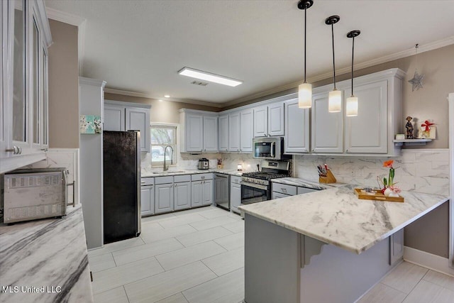 138 Oak Ridge Cir, Madison, MS 39110 - kitchen with stainless steel appliances, a peninsula, gray cabinets, decorative backsplash, and pendant lighting