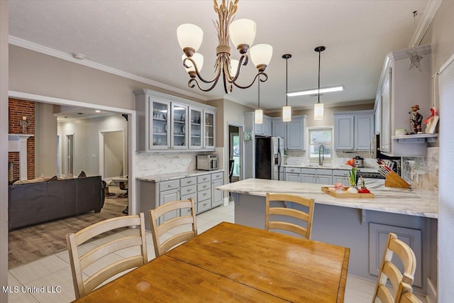 138 Oak Ridge Cir, Madison, MS 39110 - dining space with crown molding, light tile patterned floors, and a chandelier