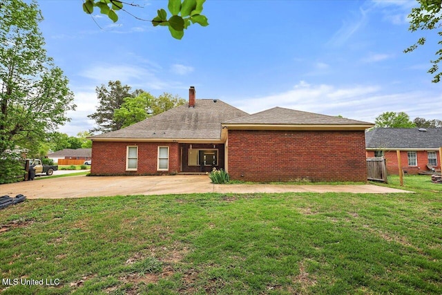 138 Oak Ridge Cir, Madison, MS 39110 - back of house featuring a lawn, brick siding, a chimney, and a patio area