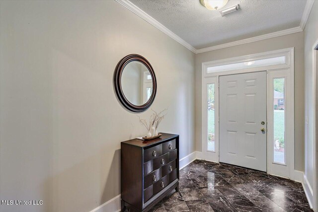 138 Oak Ridge Cir, Madison, MS 39110 - foyer featuring a textured ceiling, dark marble finish floors, baseboards, and crown molding