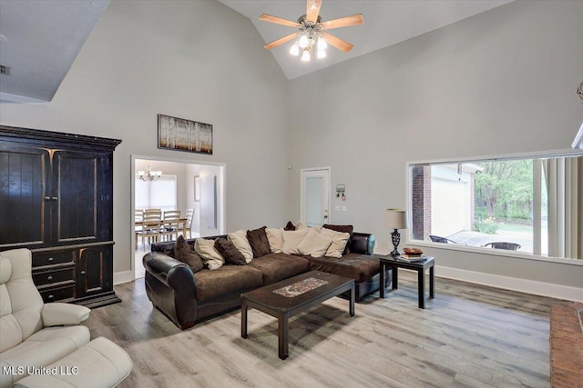 138 Oak Ridge Cir, Madison, MS 39110 - living area with high vaulted ceiling, a ceiling fan, light wood-type flooring, a chandelier, and baseboards