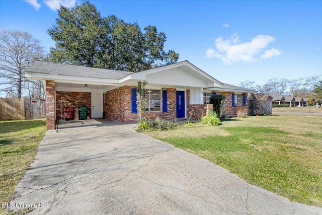 ranch-style home featuring a front yard, covered porch, and a carport