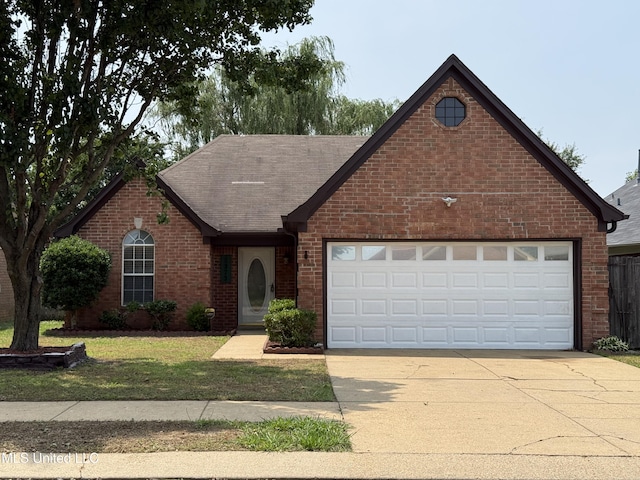 8373 Clubview Dr, Olive Branch, MS 38654 - view of front facade with brick siding, driveway, a garage, a front yard, and roof with shingles