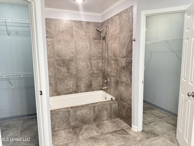 8373 Clubview Dr, Olive Branch, MS 38654 - bathroom featuring tiled shower / bath, crown molding, and a walk in closet