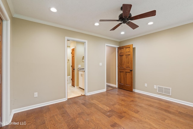 241 Cowtown Rd, Senatobia, MS 38668 - unfurnished bedroom featuring recessed lighting, light wood-style flooring, ornamental molding, ensuite bath, and a ceiling fan