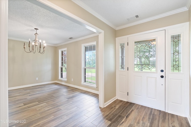 241 Cowtown Rd, Senatobia, MS 38668 - entryway with a chandelier, wood finished floors, plenty of natural light, crown molding, and a textured ceiling
