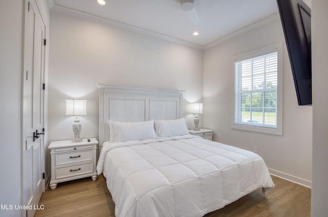bedroom featuring baseboards, wood finished floors, recessed lighting, and ornamental molding