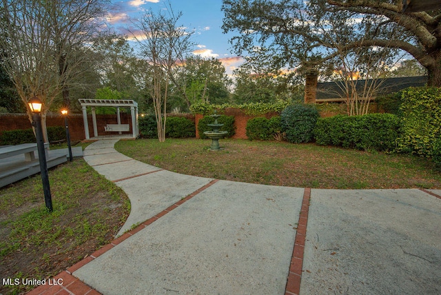 surrounding community featuring a yard and a pergola