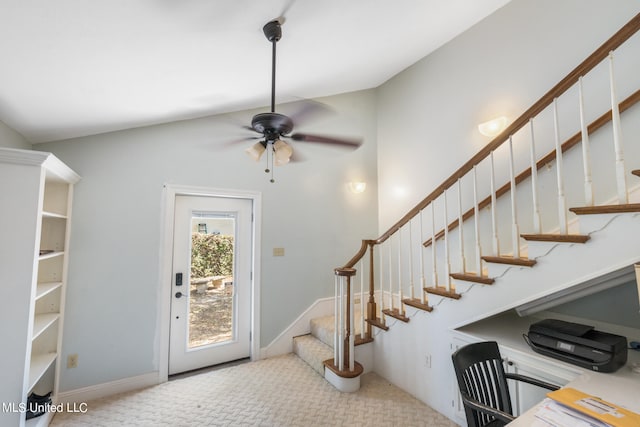 foyer featuring light carpet, lofted ceiling, and ceiling fan