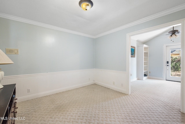 empty room featuring crown molding, light colored carpet, and ceiling fan