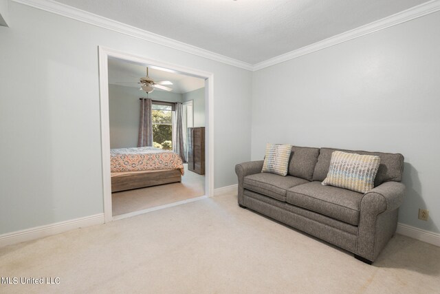 living room featuring ornamental molding, light carpet, and ceiling fan