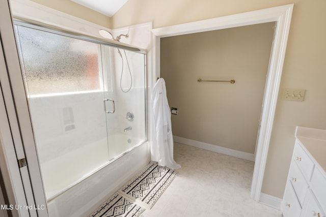 bathroom featuring vanity, lofted ceiling, and bath / shower combo with glass door